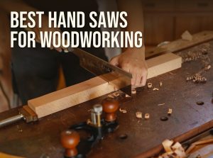 Best hand saws for woodworking: a woodworker cutting a board with a Japanese-style saw at a bench