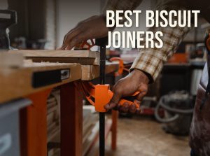 Best biscuit joiner: a woodworker clamping boards on a workbench for a glue-up