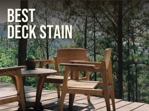 Best deck stain: a stained wooden deck with timber chairs and a table among pine trees
