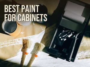 Open paint cans, brushes and a foam roller in a tray on a drop cloth, with the title Best Paint for Cabinets