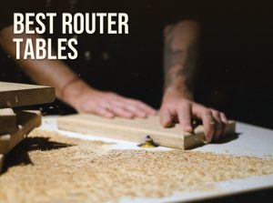 Best router table: a woodworker feeding a board past a router bit on a router table