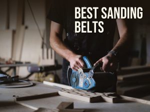 Best sanding belts: a woodworker running a belt sander along a board