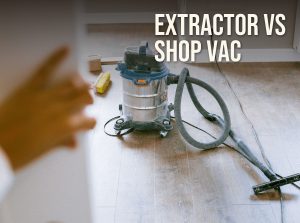 Dust extractor vs shop vac: a stainless wet/dry vacuum with its hose on a wood floor