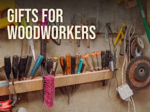 Gifts for woodworkers: chisels, screwdrivers, pliers and saw blades hanging on a workshop wall