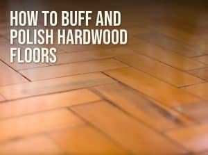 How to buff and polish hardwood floors: a glossy herringbone wood floor catching the light