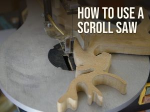 How to use a scroll saw: a reindeer pattern cut from MDF on a scroll saw table under the hold-down foot